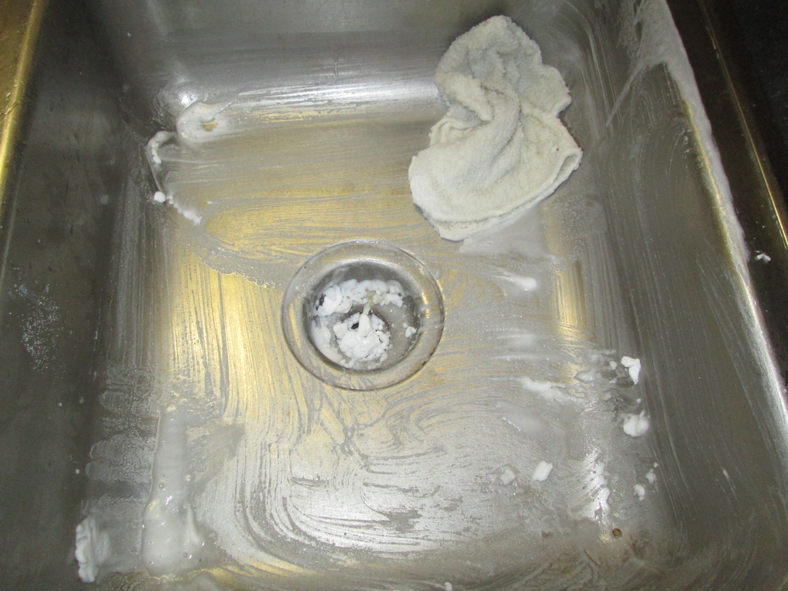 sink being scrubbed