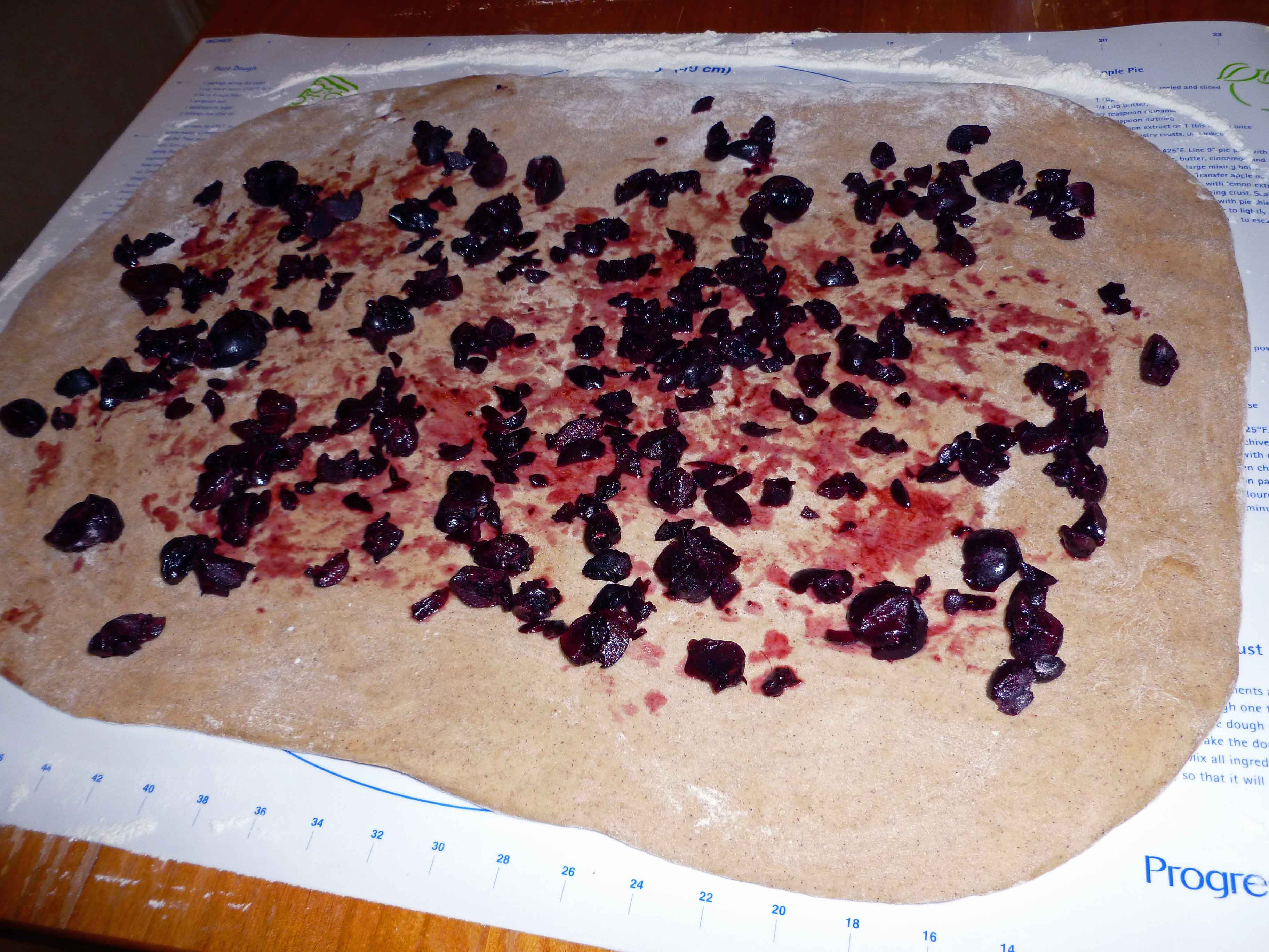 Dough with Cherries Spread over Surface