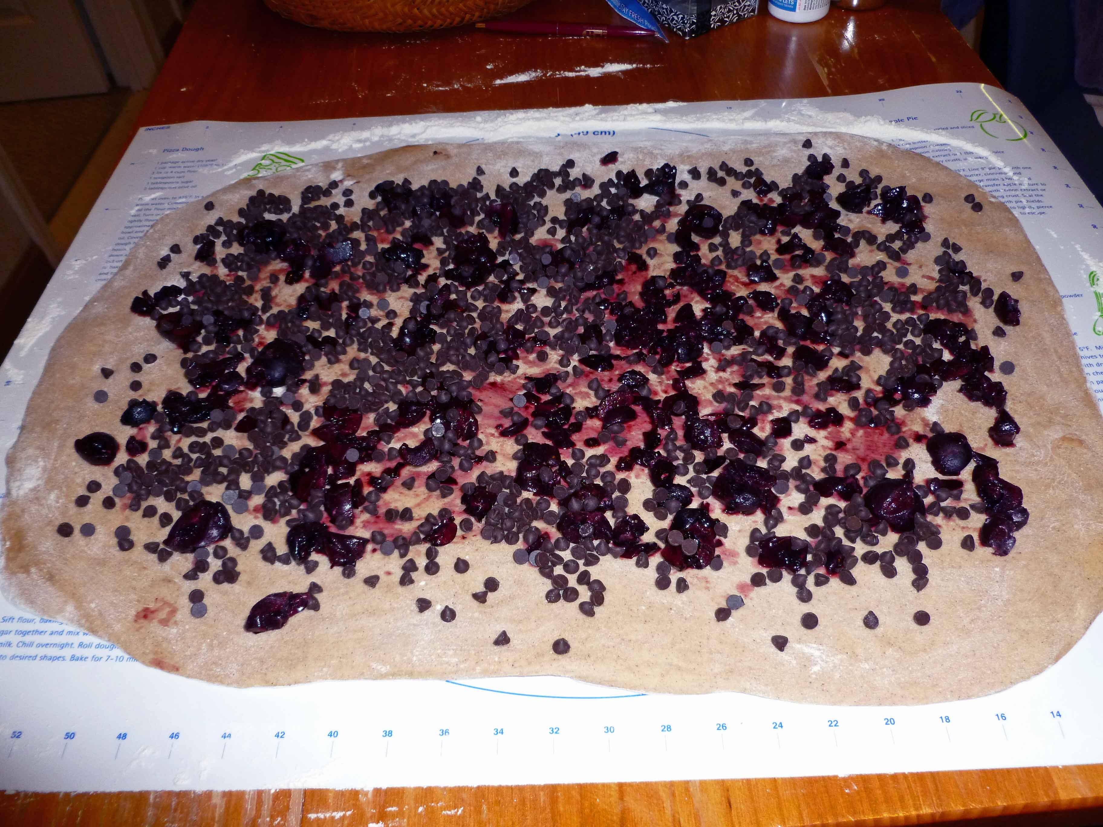 Chocolate Chips and Cherries Spread over Surface of Dough