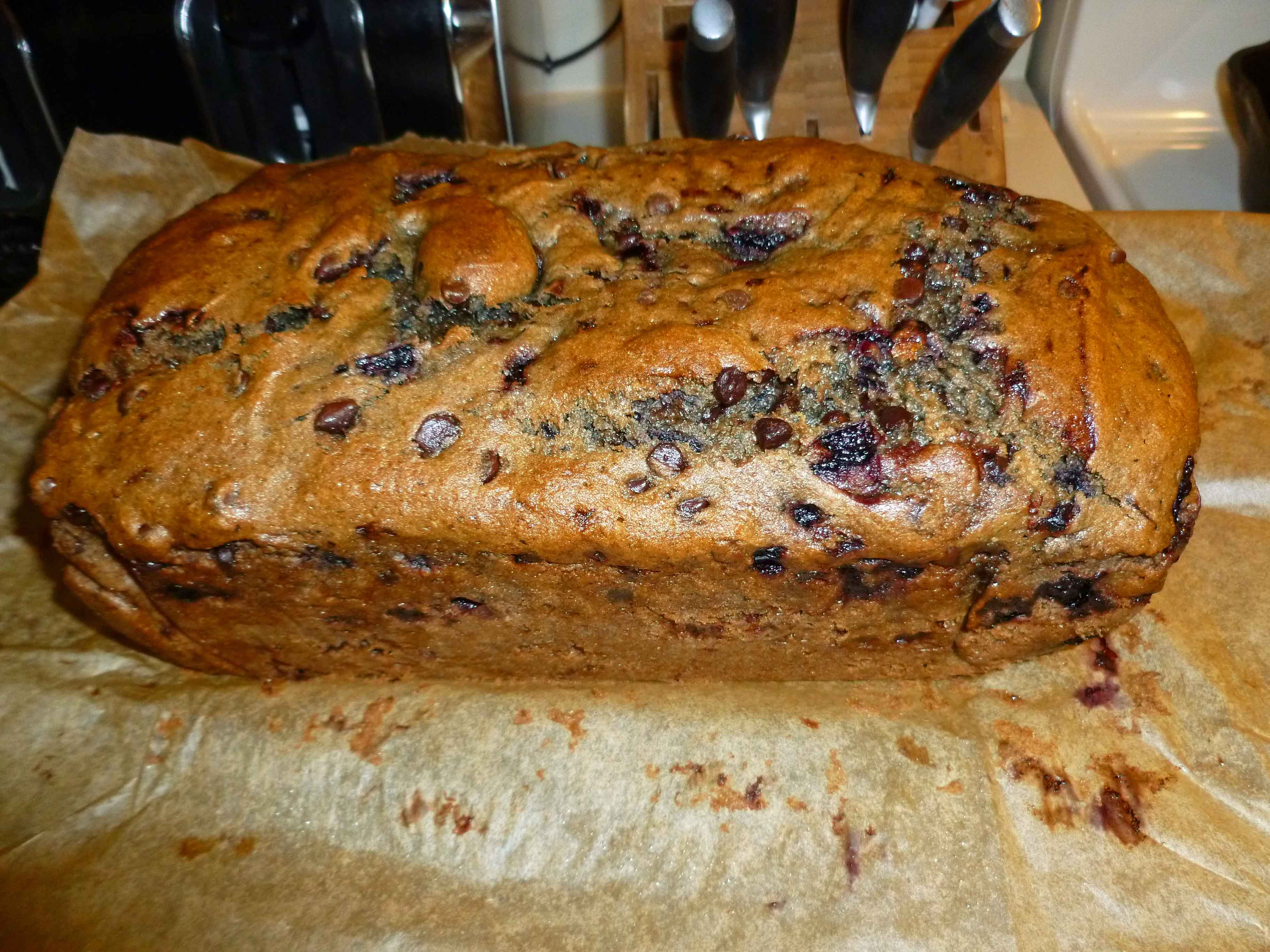 Baked Loaf on Wire Rack with Parchment Peeled Down