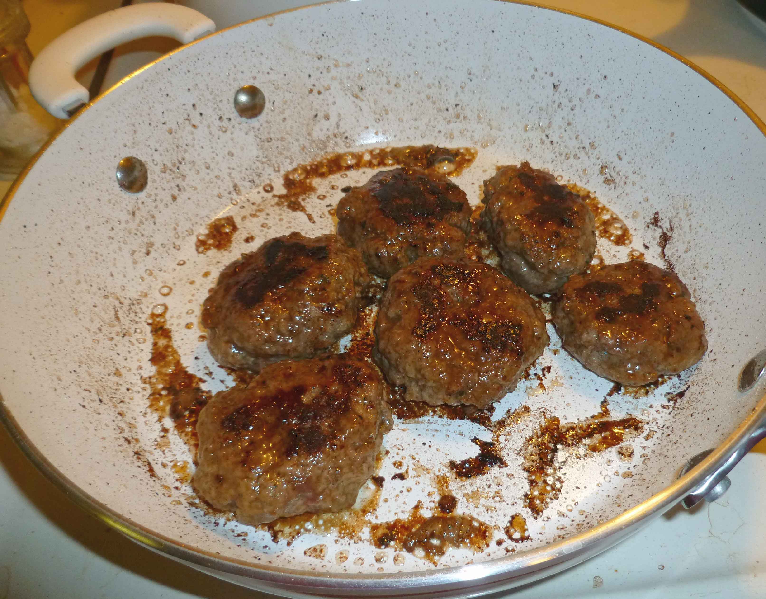 Patties frying in skillet