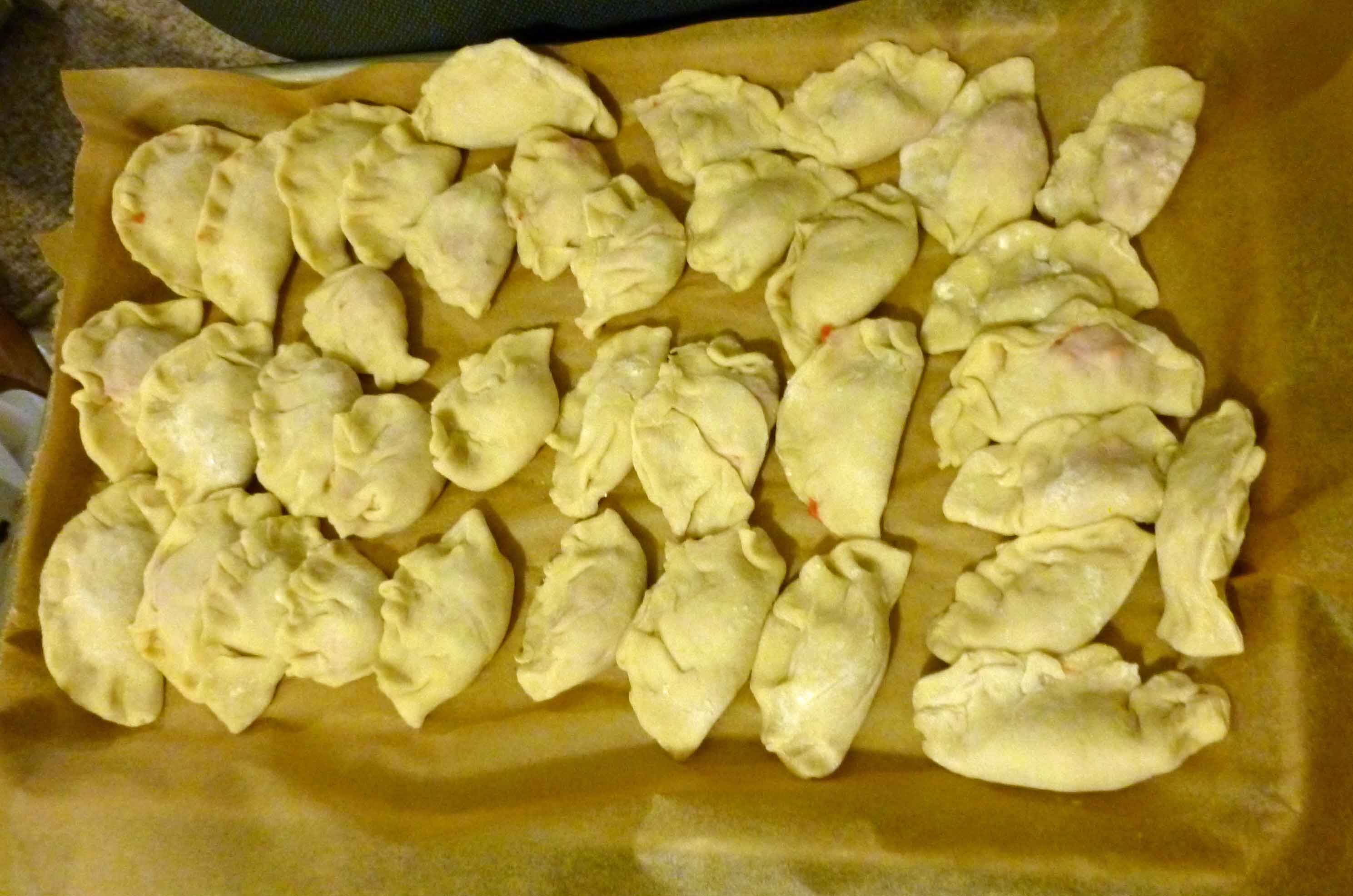 Dumplings on a sheet pan covered with parchment paper