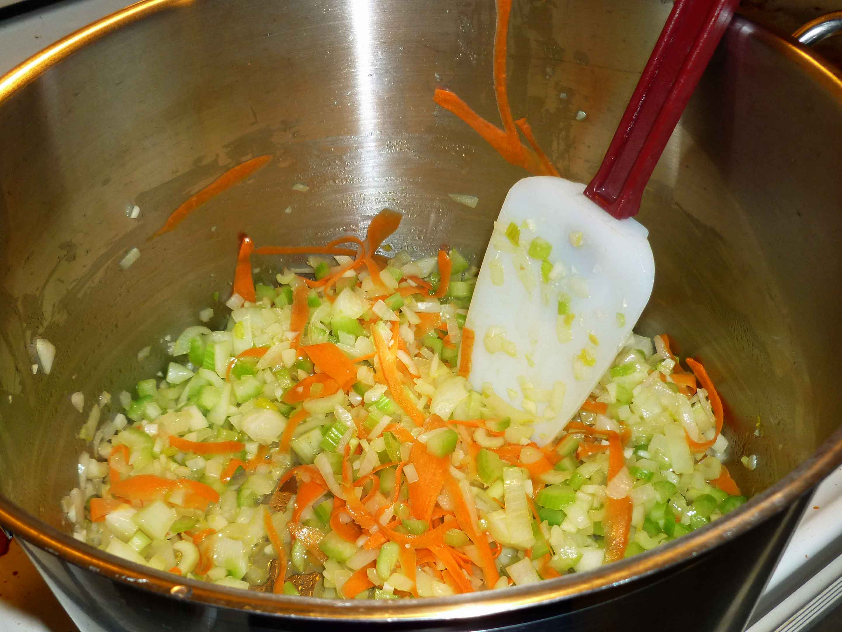 Onions, celery, garlic, and carrots being sauted