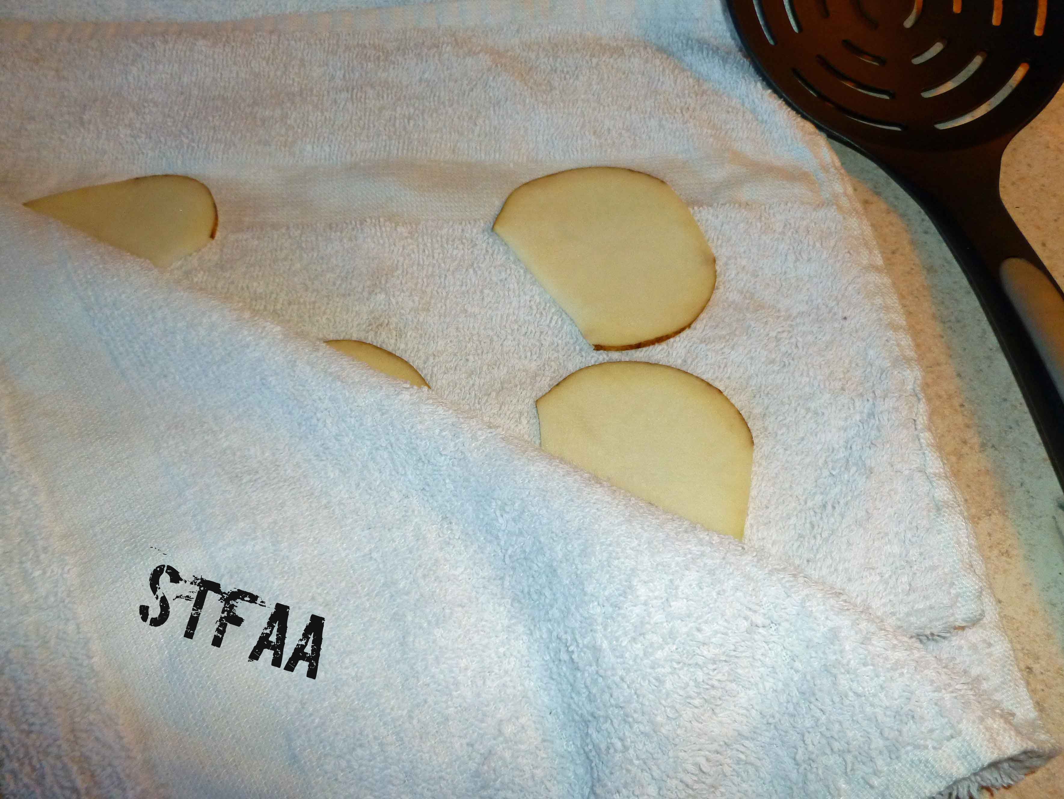 Fold towel over slices to dry both sides