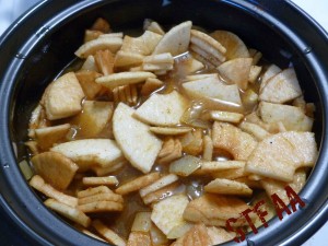 Apples and vegetable stock added to the onion and spice mixture