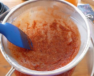 Straining Apple Cranberry Habanero Hot Sauce