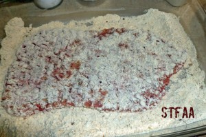 Cube steak after first dredge in flour mixture