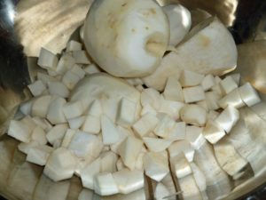 Peeled turnip being cut into cubes