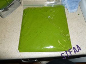 Pesto started placed in zip top freezer bag ready to freeze