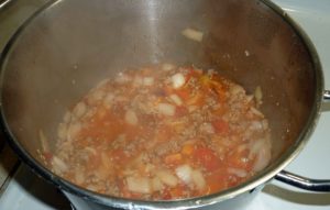 Ground pork, onions and tomato mixture after tomatoes have cooked to sauce