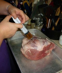 Brine being injected into the pork