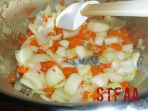 Onions, garlic and orange bell pepper sauteing in Instant Pot