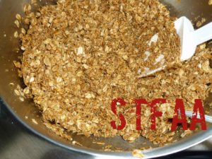 Toasted oats and cashews coated with the syrup and sugar mixture