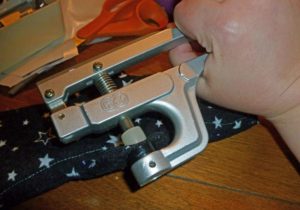 Use the snap setting pliers to set the snap in place